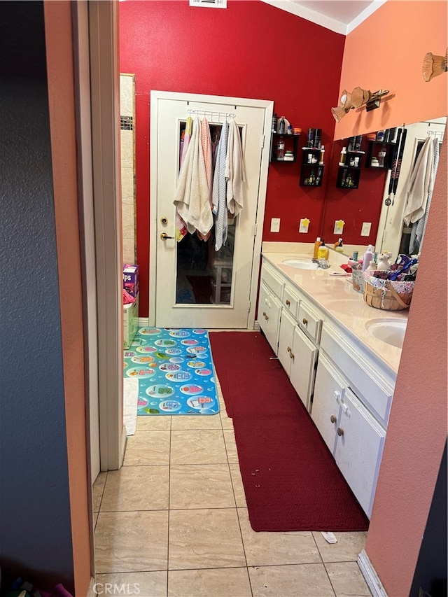 bathroom featuring vanity, crown molding, and tile patterned flooring