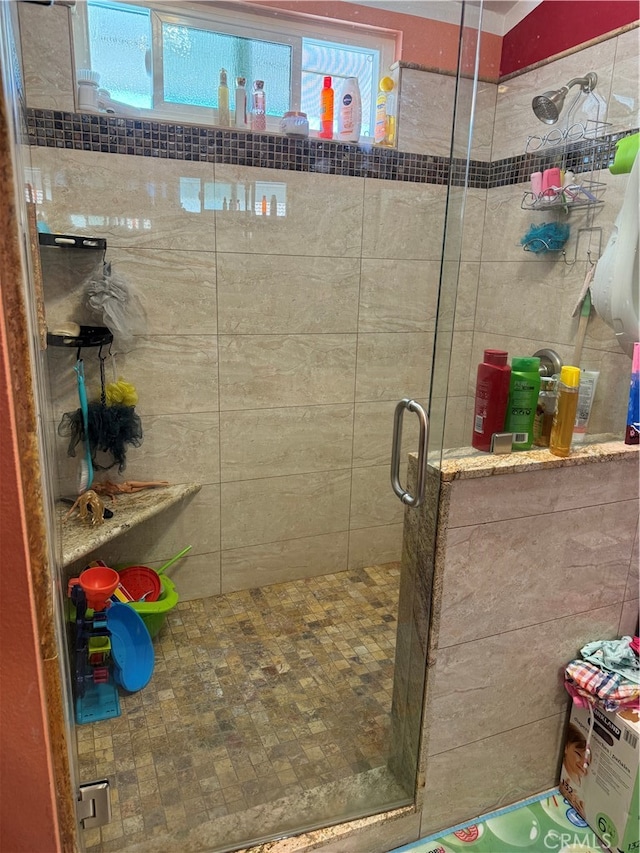 bathroom featuring a shower with shower door