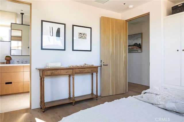 bedroom featuring sink, dark wood-type flooring, and a closet