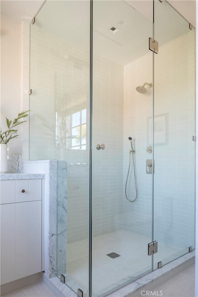 bathroom with a shower with door