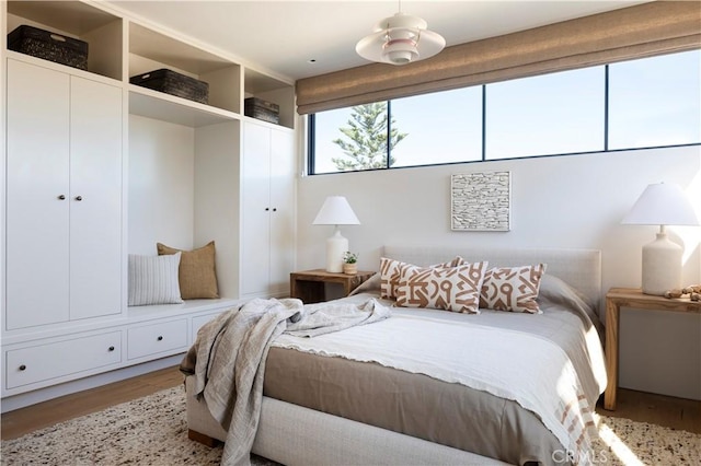 bedroom featuring wood-type flooring, a closet, and ceiling fan