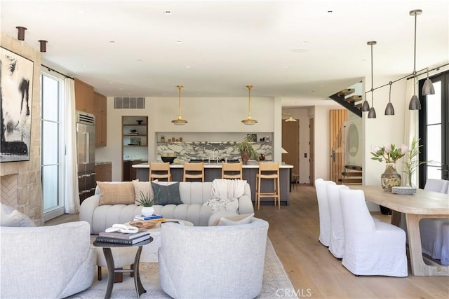 living room with plenty of natural light and light hardwood / wood-style floors