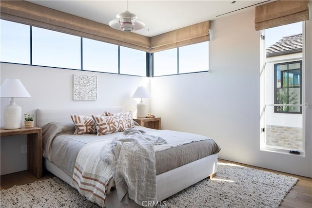 bedroom with light wood-type flooring and ceiling fan