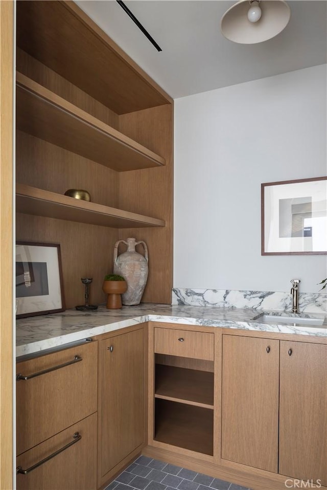 kitchen with light stone counters and sink