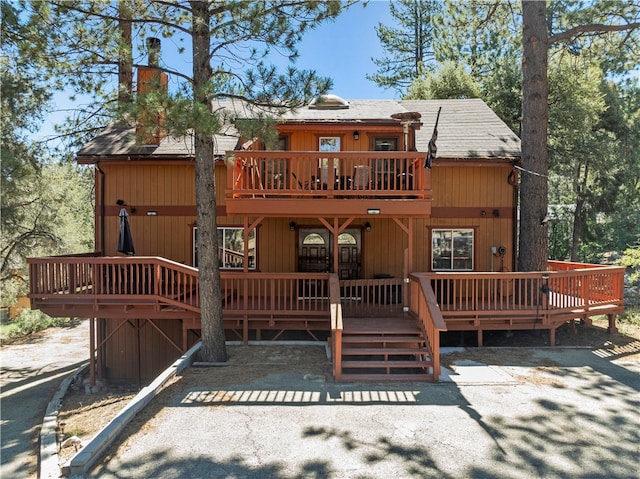 back of property with a wooden deck