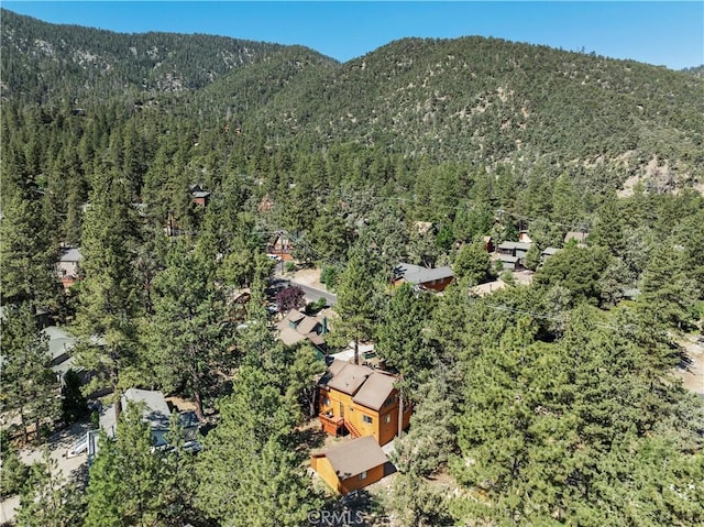 drone / aerial view with a forest view and a mountain view