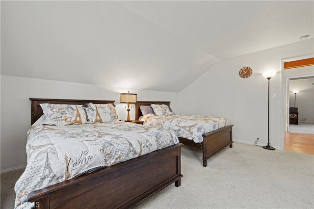 bedroom featuring light carpet and lofted ceiling