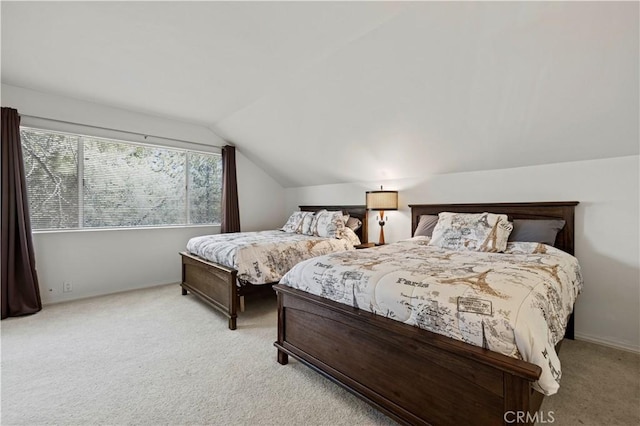 bedroom with vaulted ceiling, carpet, and baseboards