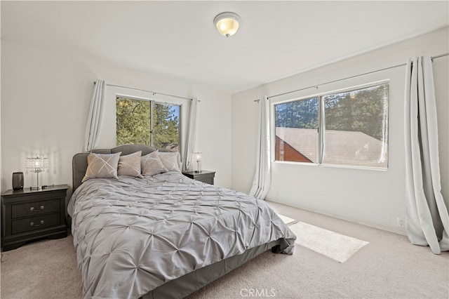 bedroom featuring light carpet