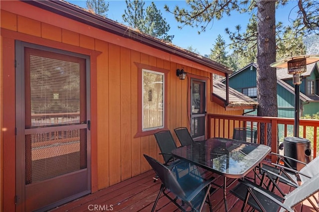 wooden deck featuring outdoor dining area