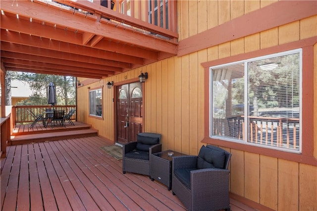 deck with outdoor dining area and french doors
