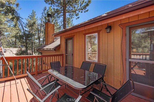 wooden deck featuring outdoor dining area