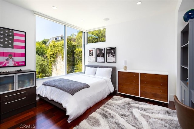 bedroom with wood finished floors and recessed lighting