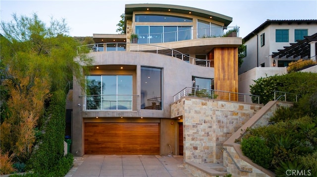 view of front facade featuring a balcony and a garage