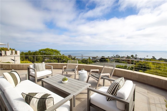 balcony with an outdoor living space and a water view