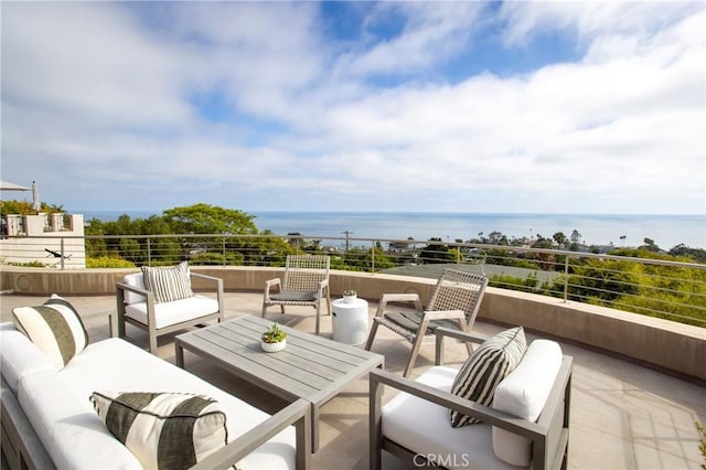 view of patio featuring an outdoor living space, a water view, and a balcony