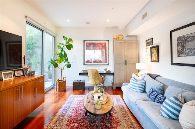living room with visible vents, wood finished floors, and recessed lighting