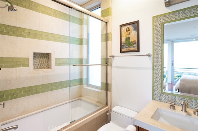 full bathroom with vanity, toilet, enclosed tub / shower combo, and tasteful backsplash