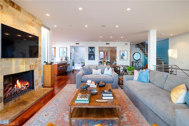 living room featuring dark hardwood / wood-style floors and a fireplace