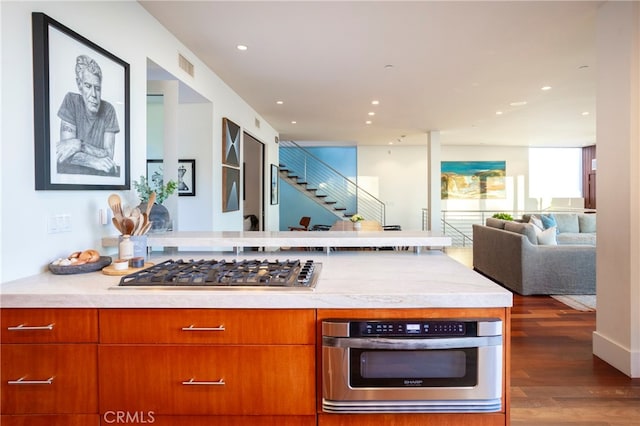 kitchen with appliances with stainless steel finishes and dark wood-type flooring