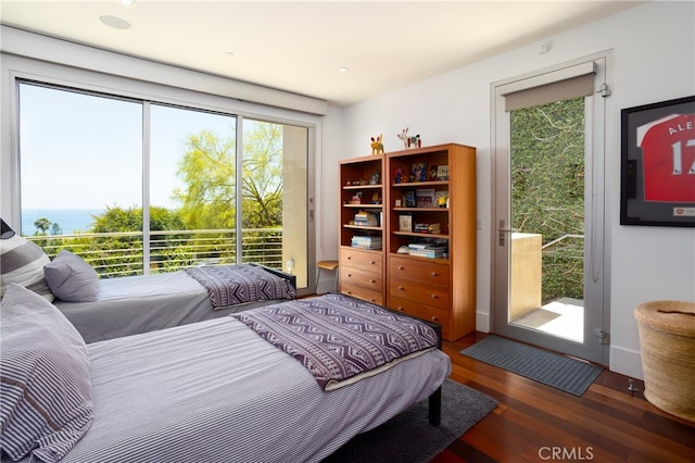 bedroom featuring access to outside and dark hardwood / wood-style flooring