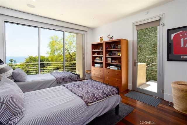 bedroom with access to exterior and wood finished floors