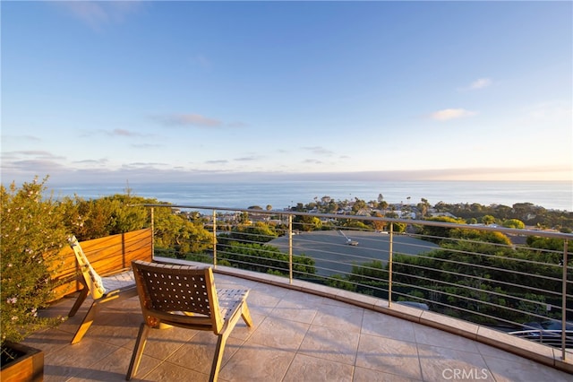 balcony at dusk with a water view