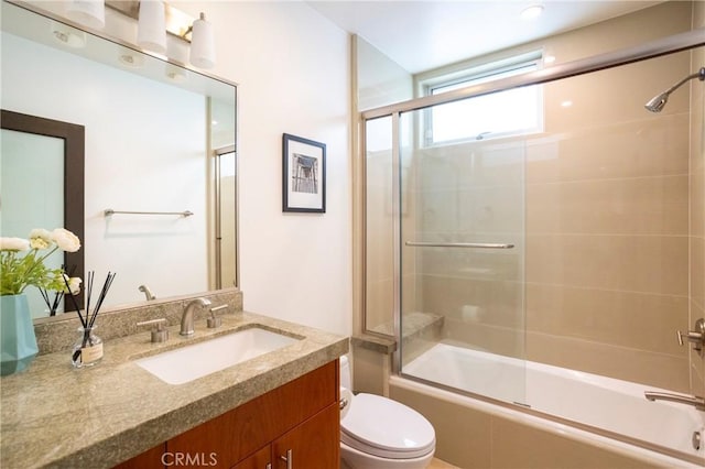 full bathroom featuring vanity, toilet, and enclosed tub / shower combo
