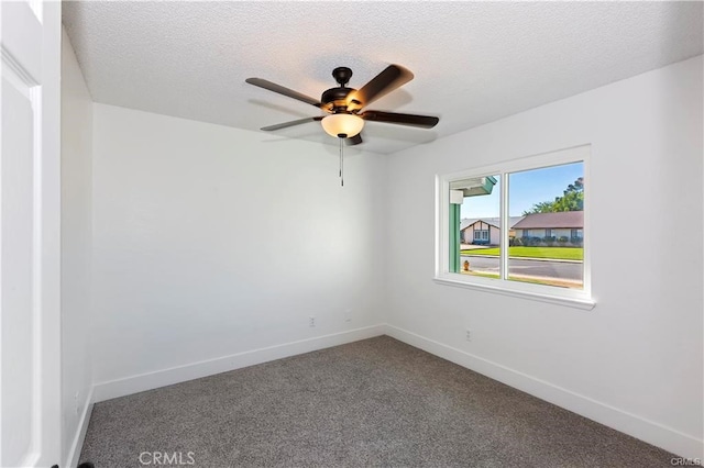 carpeted empty room featuring a textured ceiling and ceiling fan