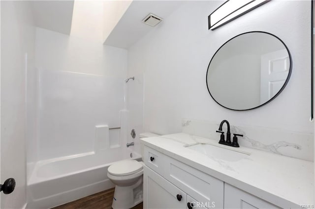 full bathroom with shower / tub combination, vanity, toilet, and hardwood / wood-style floors