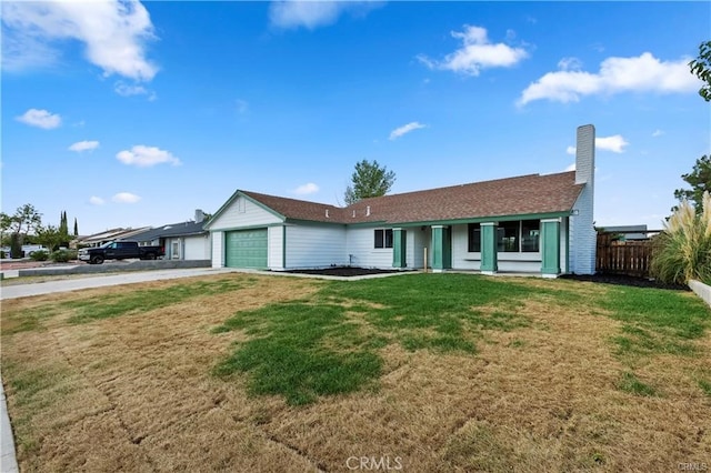 single story home with a garage and a front lawn