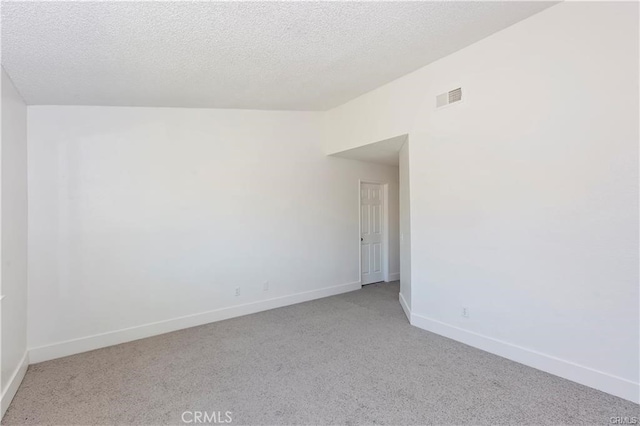 spare room with a textured ceiling