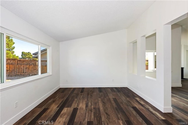 unfurnished room featuring dark hardwood / wood-style floors