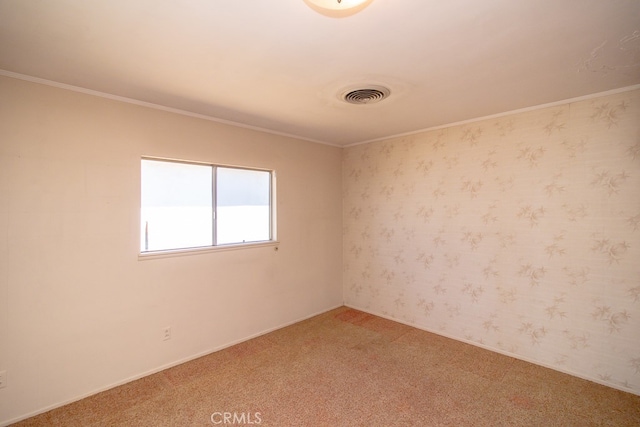 carpeted spare room featuring crown molding