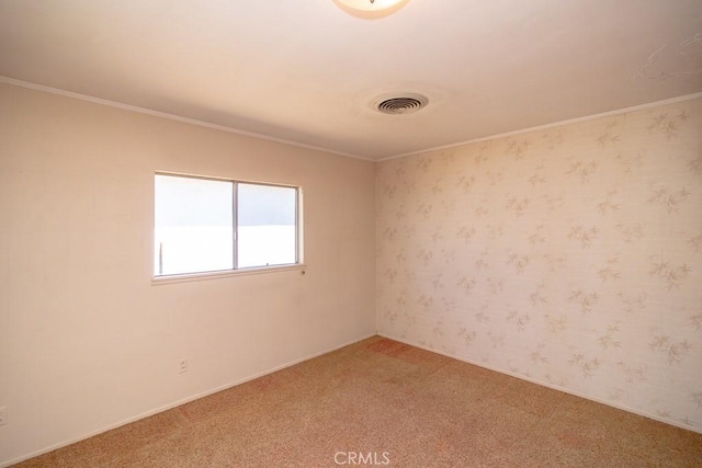 empty room featuring visible vents, wallpapered walls, crown molding, and light carpet