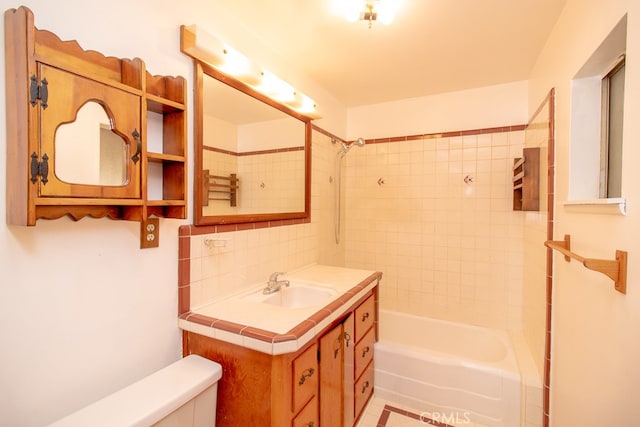 full bathroom with toilet, tiled shower / bath combo, tasteful backsplash, and vanity