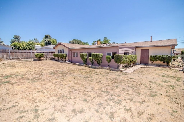 rear view of property with fence