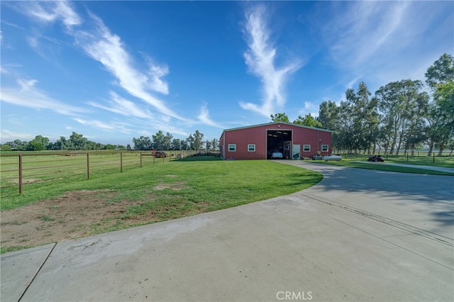 view of yard with an outbuilding and a rural view