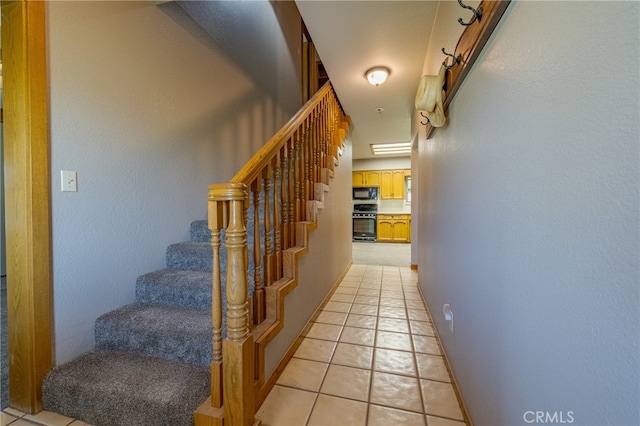 stairway featuring tile patterned floors