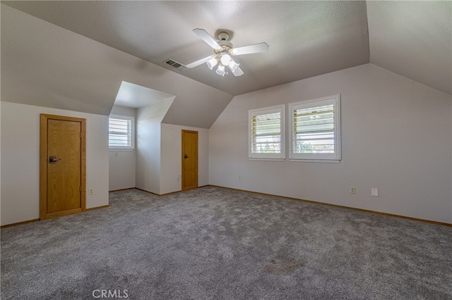 additional living space with carpet, lofted ceiling, ceiling fan, and a textured ceiling