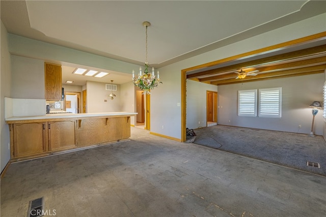 interior space featuring ceiling fan with notable chandelier and beamed ceiling