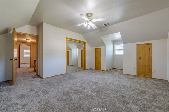 bonus room with ceiling fan, light colored carpet, and vaulted ceiling