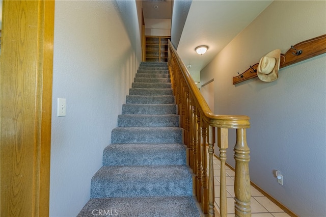 stairs featuring tile patterned flooring