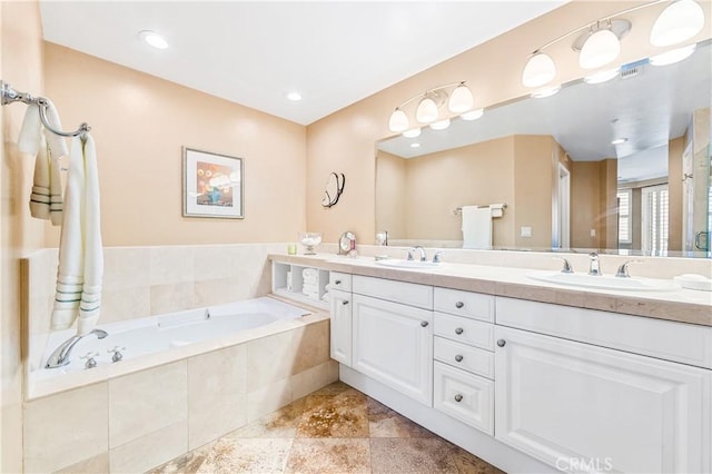 bathroom with double vanity, a sink, and a bath