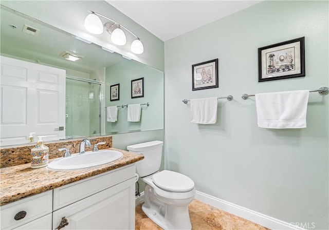 full bathroom featuring toilet, a shower stall, vanity, baseboards, and tile patterned floors