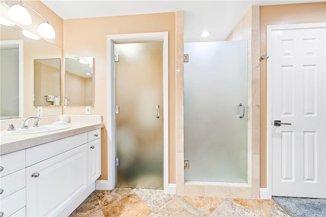 bathroom featuring a shower stall and vanity