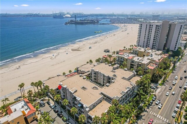 drone / aerial view featuring a beach view and a water view