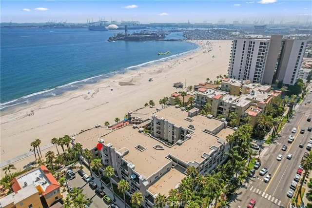 drone / aerial view featuring a beach view and a water view