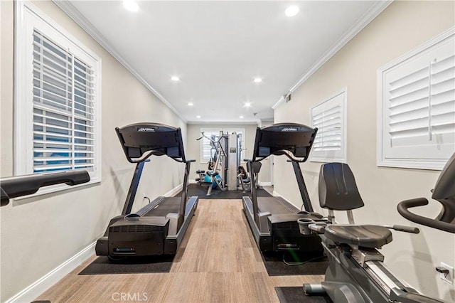 workout area with recessed lighting, crown molding, baseboards, and wood finished floors