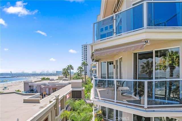 view of home's exterior featuring a city view, a balcony, and stucco siding